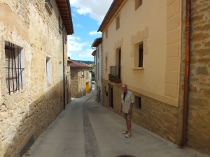Dale in shade on side street in Villatuerta. The wind and sun is really hurting the abrasions  on his face